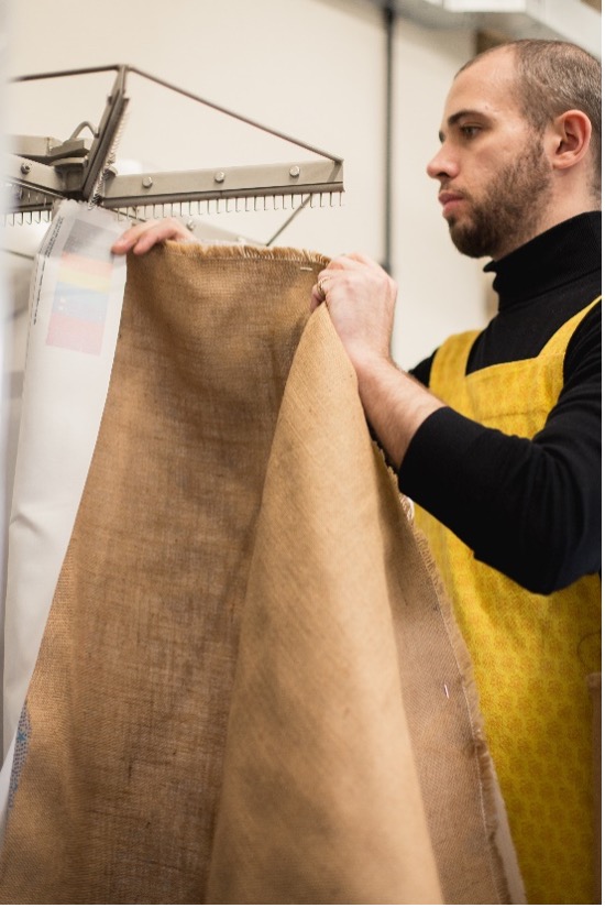 A member of the team at Doc Cotton working with fabric