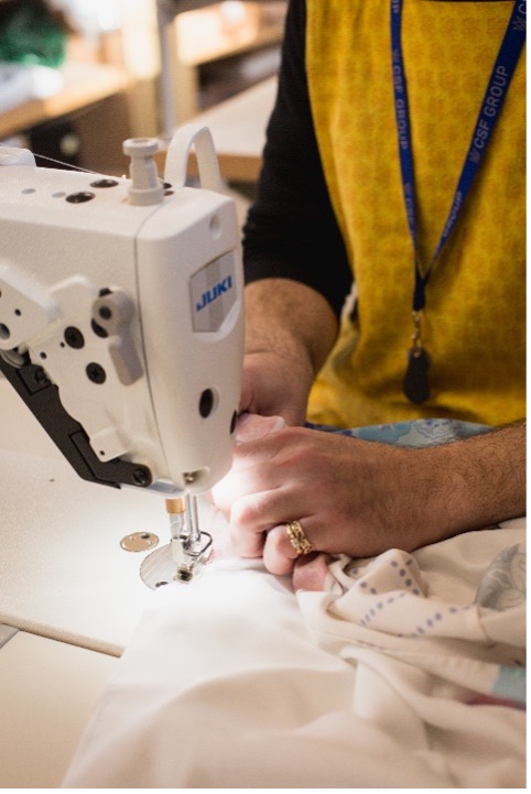 A member of the team at Doc Cotton using a sewing machine