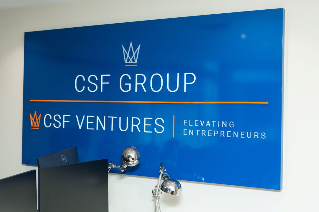 CSF Group & CSF Adventures logo image sign on wall